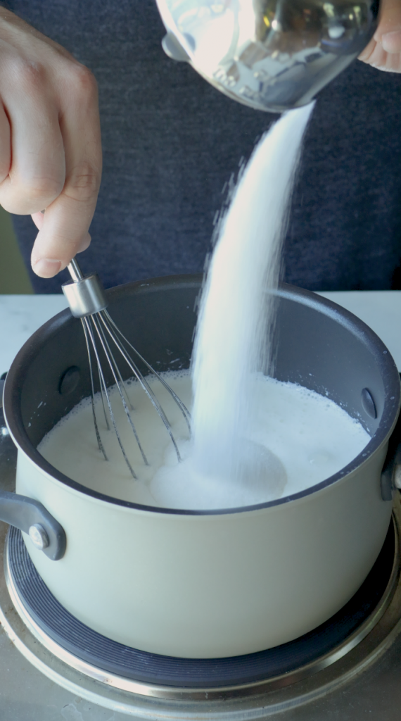 5. Make sure to stir constantly to avoid the milk sticking.
6. Then add sugar, ground cardomom, and the vanilla.